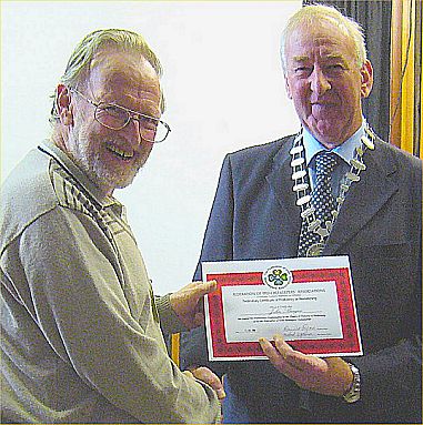 John Burgess receiving his certificate from Dennis Ryan